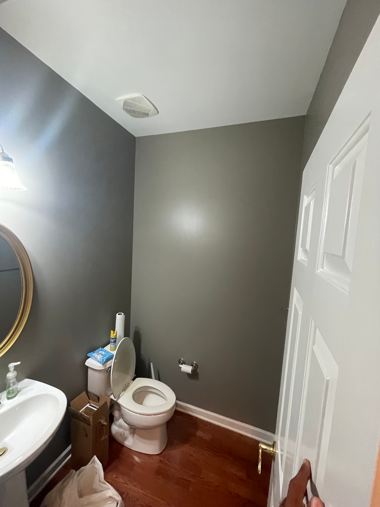 Wide view of powder room with updated gray walls and bright white ceiling
