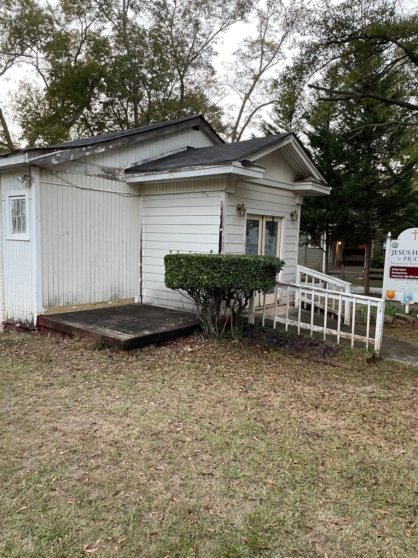 Small church exterior in need of siding repair and exterior paint