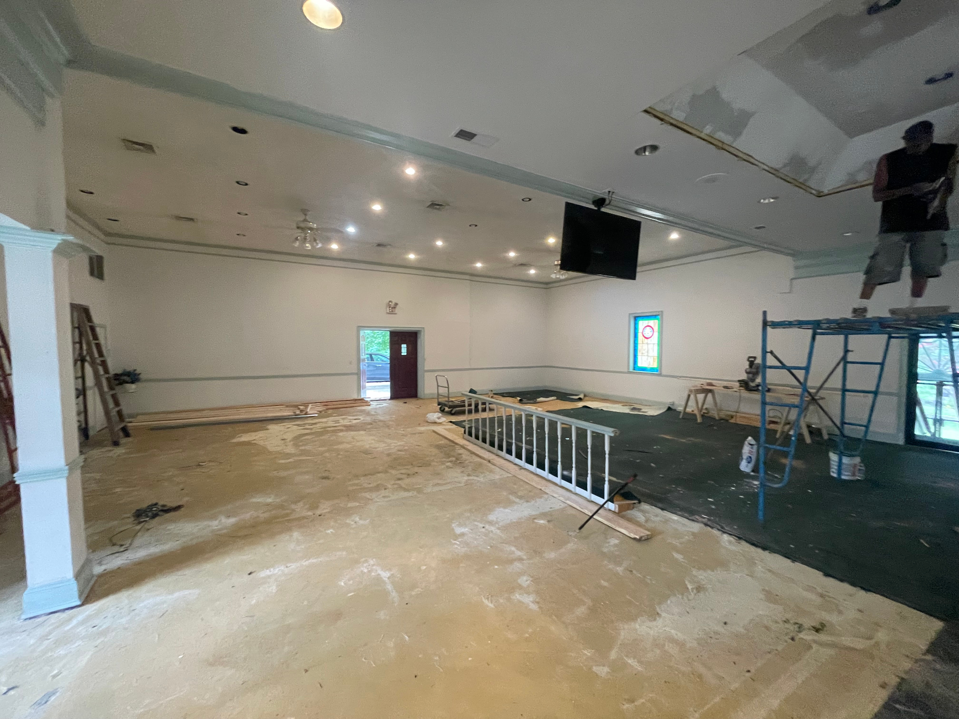 Church interior prepped for renovation with flooring removed and walls ready for paint
