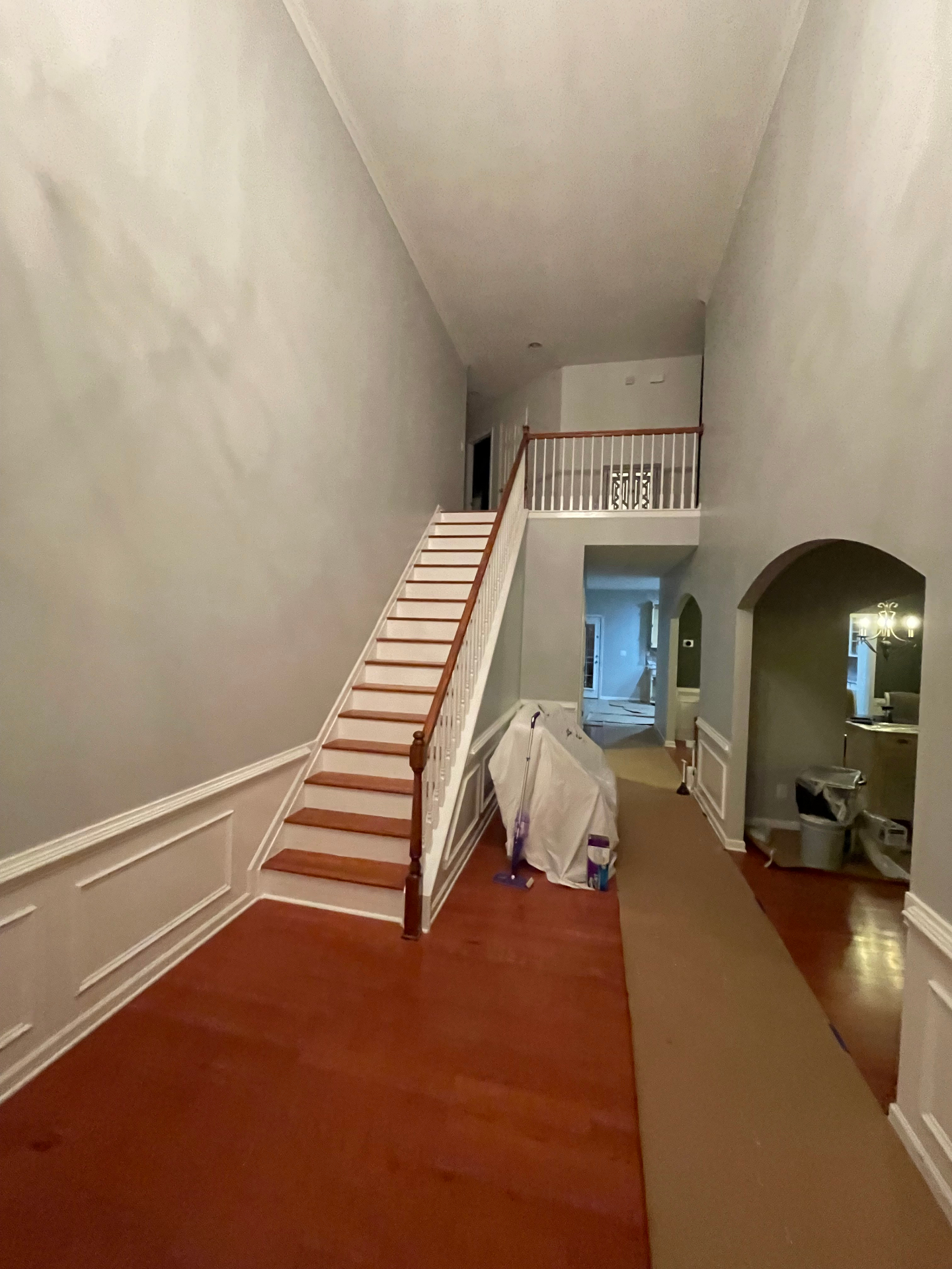 Two-story foyer with taupe walls and dated finishes before renovation