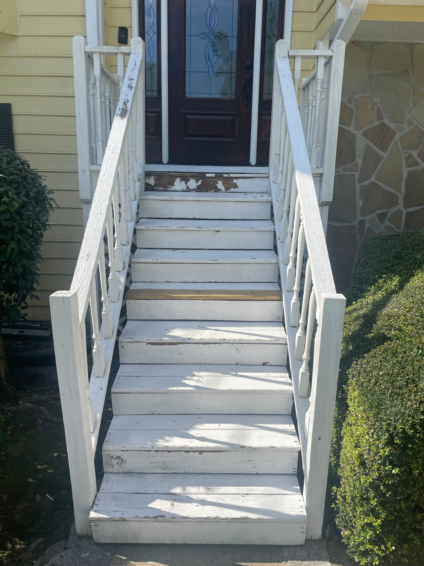 Weathered front entry stairs with peeling paint — before restoration